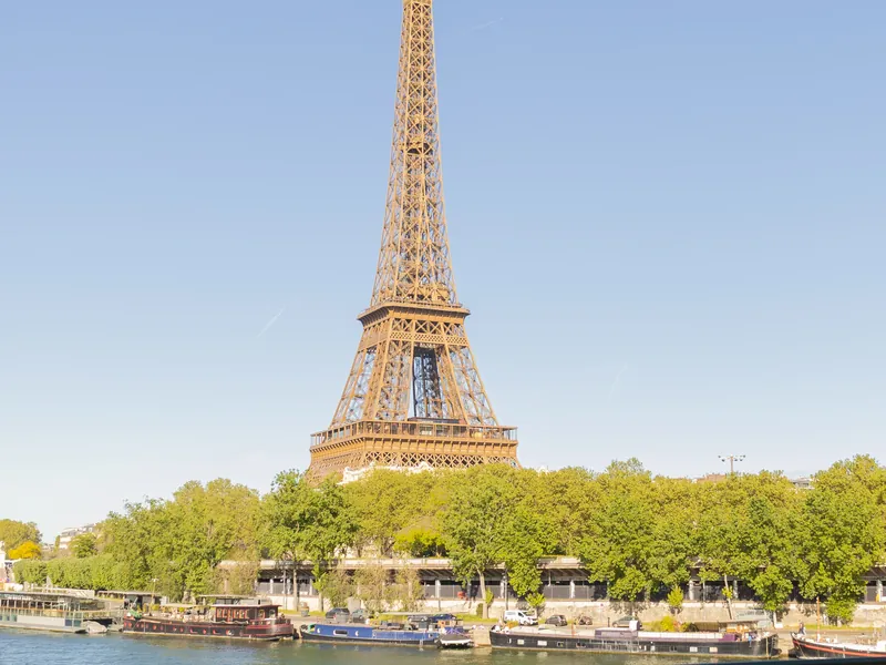 The Eiffel Tower seen from the Seine, above the moored barges